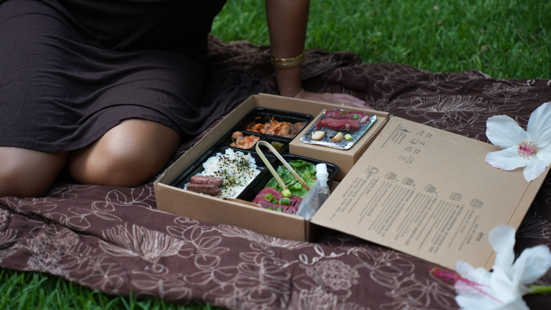 A person sitting on the ground with some food in it