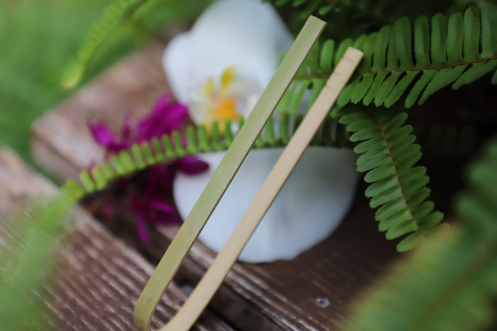 A pair of bamboo chopsticks sitting on top of a table.